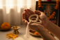 White Tulsi Japa Mala held in hands during meditation with warm golden light