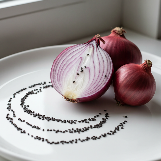Fresh red onions and seeds on a clean white surface, one sliced showing deep purple-red layers