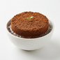 Cocopeat agropeat coin expanding in water with a tiny green seedling sprouting from the centre